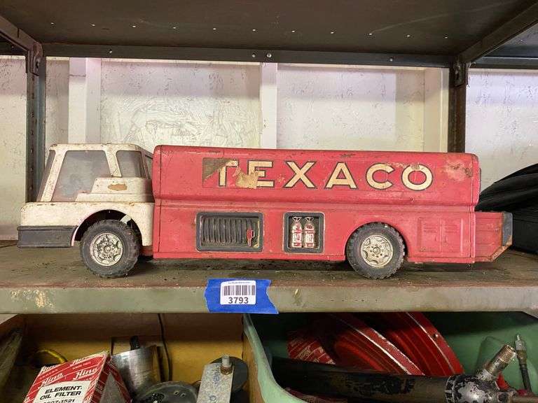 Contents of shelf: vintage Texaco toy tanker truck