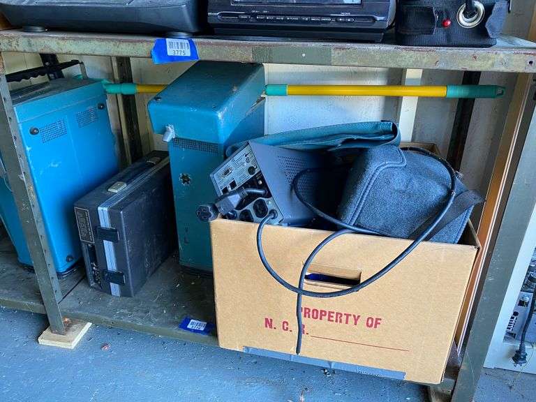 Contents of shelf: oscilloscope and misc electronics