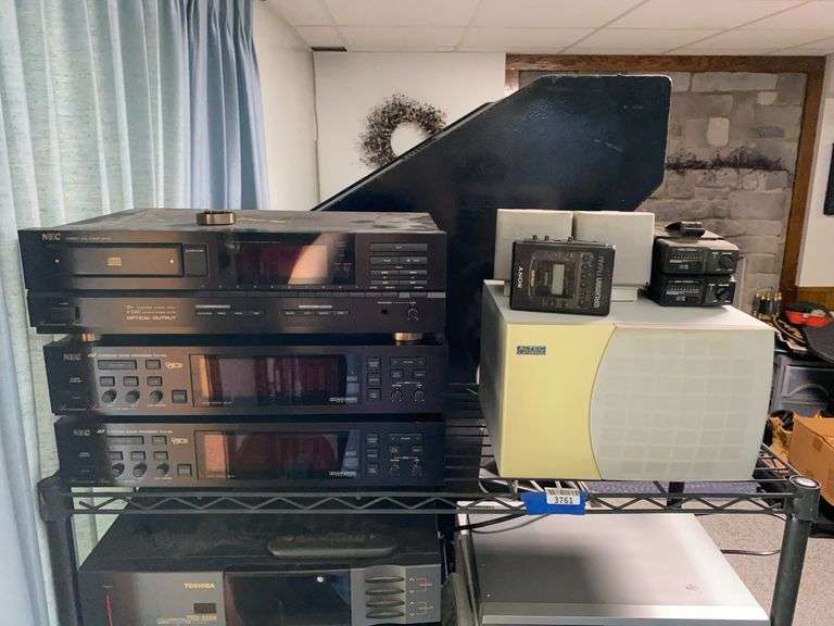 Contents of shelf: NEC stereo components, Sony Walkman, Maxon radar detectors, speakers