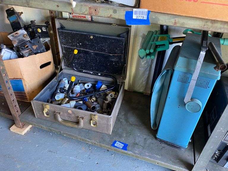 Contents of shelf: case of pipe fittings, oscilloscope, misc
