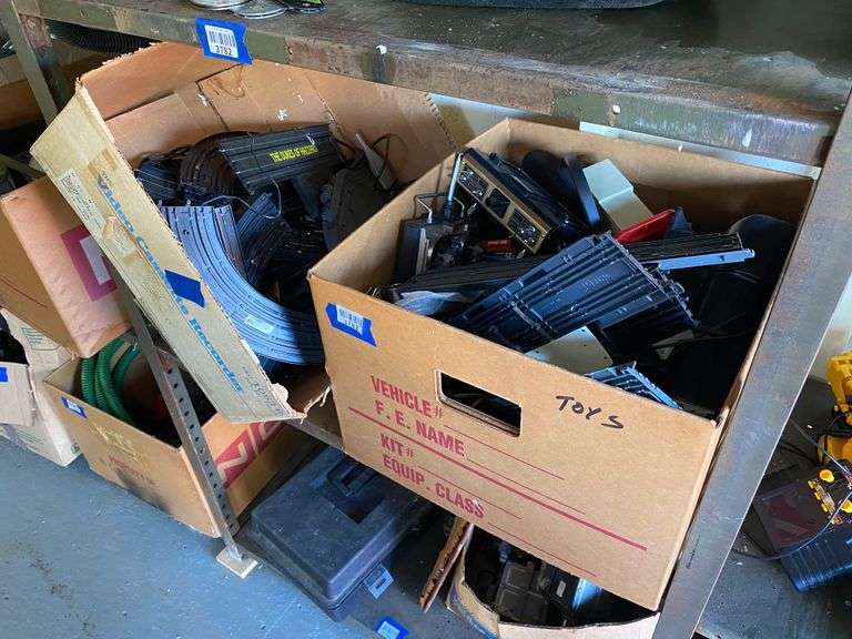 Contents of shelf: slot car tracks, cars, misc