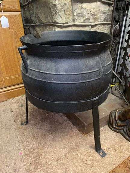Cast iron kettle on footed stand