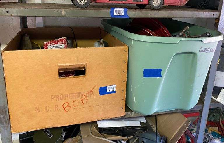Contents of shelf: filter, grease guns and more