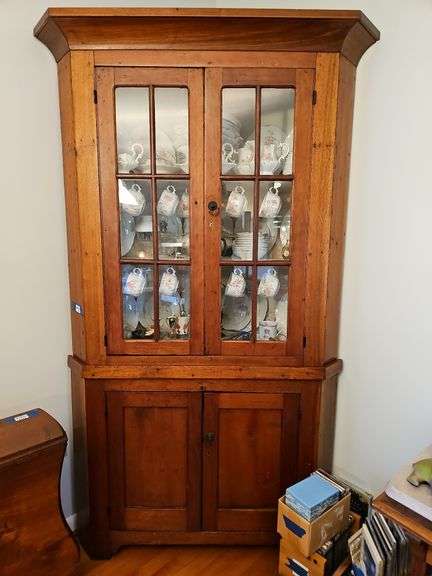 2-pc country corner cupboard w/ cove molded cornice, glazed top doors over cupboard base w/ paneled doors, sawn bracket feet - no contents 6.5 ft high, 3 ft wide MUST COME DURING LAST 2 HOURS OF PICK UP FOR THIS ITEM