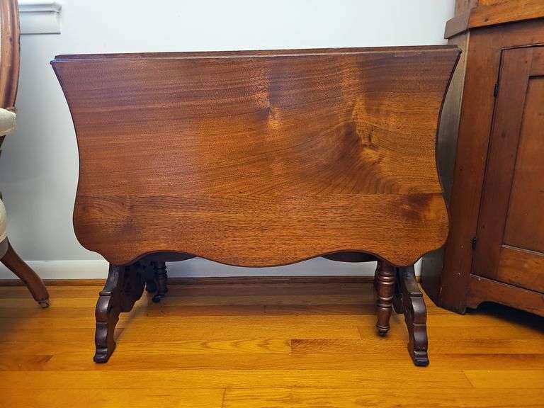 Victorian walnut drop leaf table w/ shaped top, apron panels w/ wavy molding, fancy sawn legs and stretcher, turned support legs 28 in h, 35 in w, 49 in d