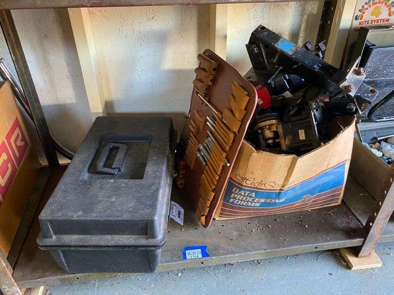 Contents of shelf: toolbox, tools hitch attachment, misc
