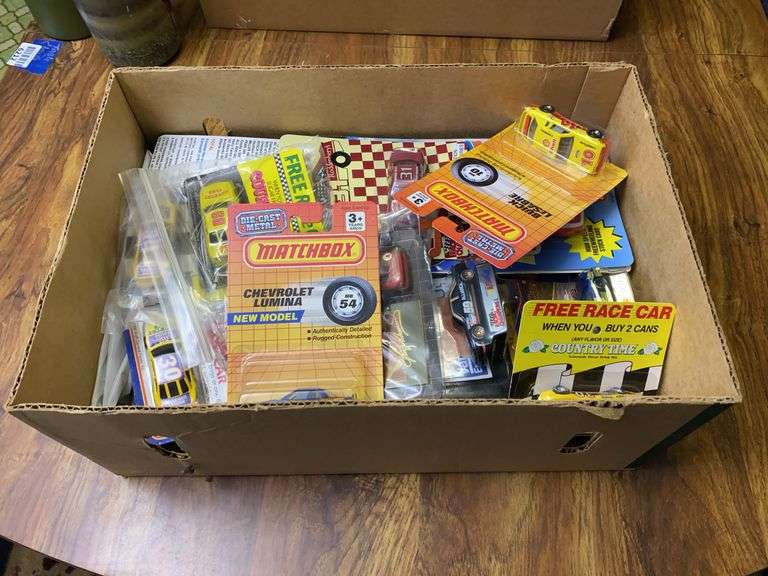 Matchbox and other race cars, in packages