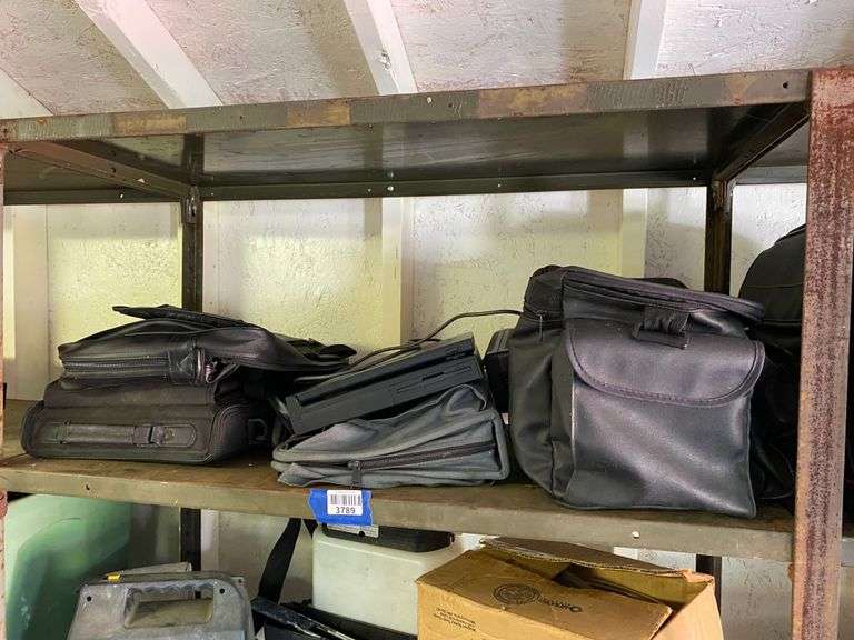 Contents of shelf: laptop, cases, misc