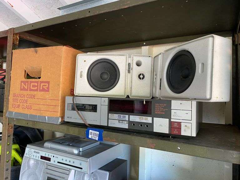 Contents of shelf: Akai stereo cassette deck, speakers, misc