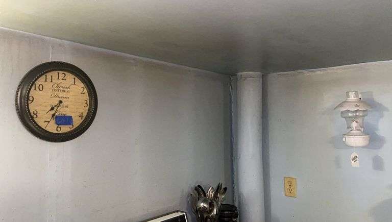 Wall hangings: wall clock and metal bracket oil lamp