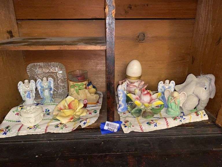 Contents of shelf: angel figurines, ceramic flowers, plush Horton elephant, pressed glass dish