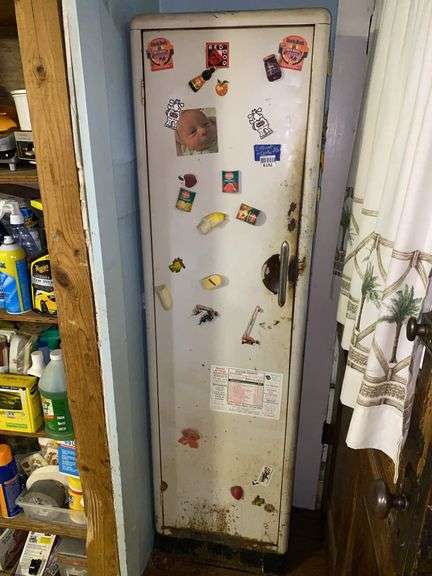 Metal storage cabinet w/ magnets and contents: glasses, mugs, storage jars, misc18x65x13
