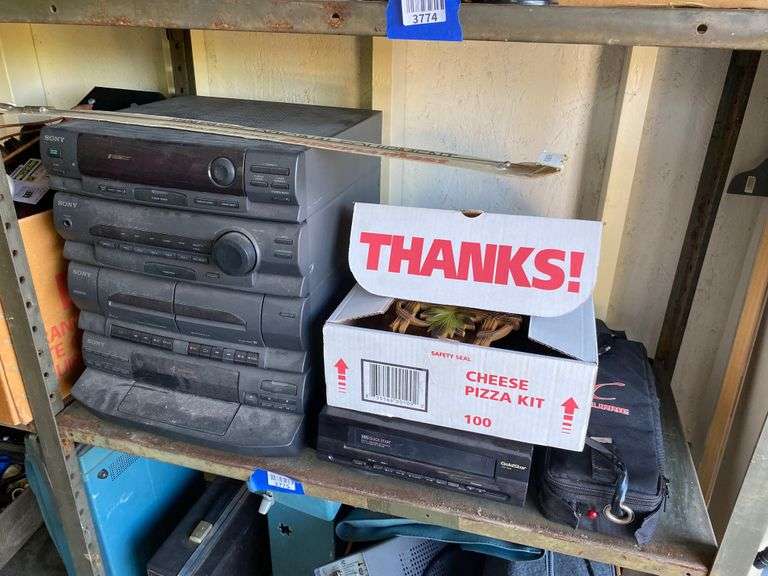 Contents of shelf: Sony stereo, GoldStar VHS player, cuckoo clock