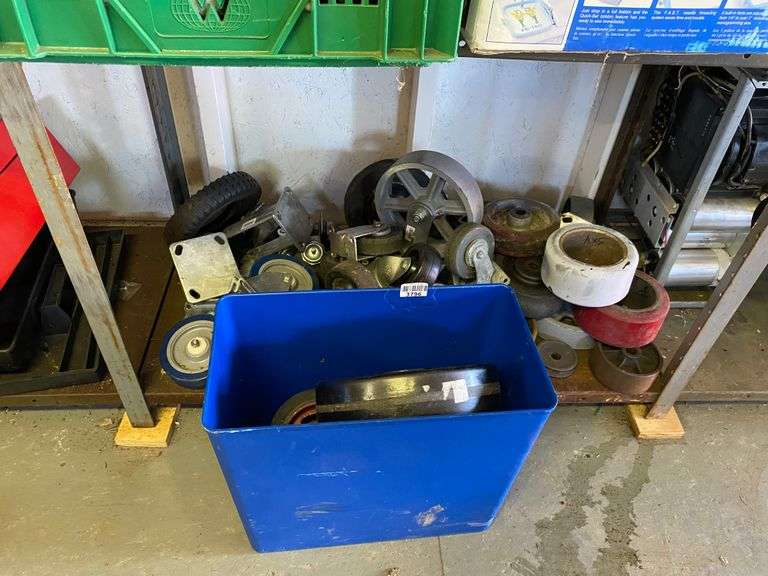 Contents of blue container and shelf with casters