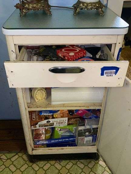 Contents of drawer and cabinet: utensils, kitchen wrap, misc kitchenware