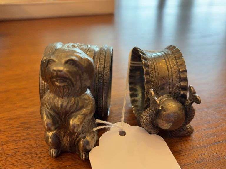 Two figural silverplate napkin rings: dog and dolphins