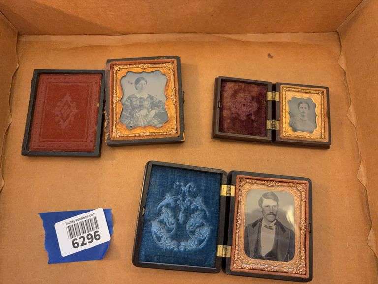 Three Victorian photographs in cases, hinge is separated on one