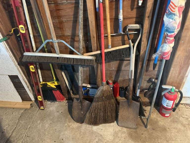 Items on The Wall - 6 Ft Level, Brooms, Dust Pans, Receiver Hitch, & More