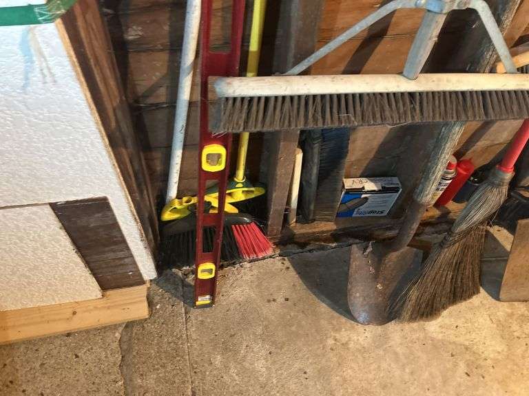 Items on The Wall - 6 Ft Level, Brooms, Dust Pans, Receiver Hitch, & More