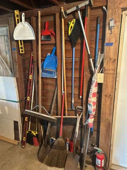 Items on The Wall - 6 Ft Level, Brooms, Dust Pans, Receiver Hitch, & More