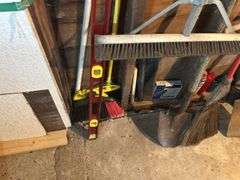 Items on The Wall - 6 Ft Level, Brooms, Dust Pans, Receiver Hitch, & More
