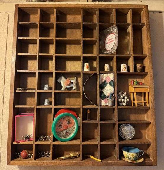 Small shelf with jacks, thimbles, a marble, Mickey Mouse cup, saucer
