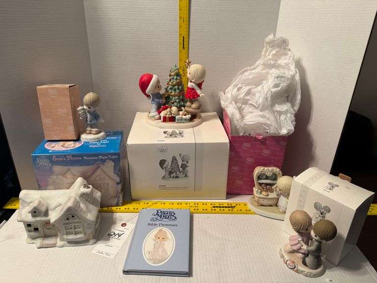 5 precious moments figurines and a book