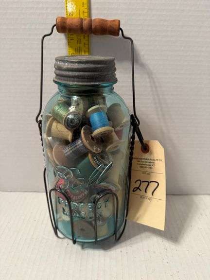 Ball jar with wooden thread spools