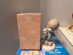 5 precious moments figurines and a book