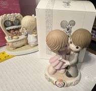 5 precious moments figurines and a book