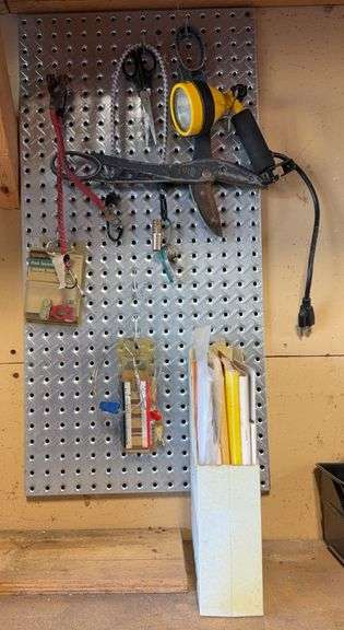 Contents Of Pegboard, Including Post Terminals, Work Light, Implement & Power Tool Manuals, and More