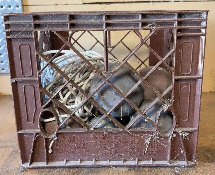 Brown HuskyLite Milk Crate With Bocce Balls & Clothesline.