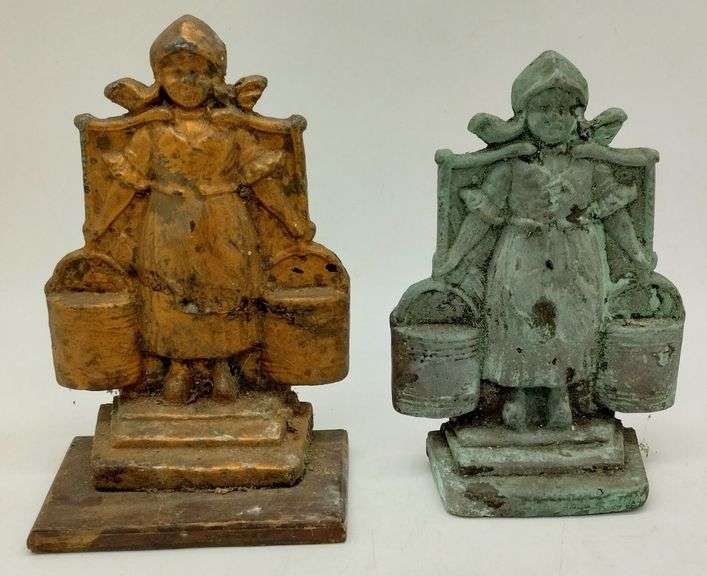 (DE) Dutch girl bookends. One is bronze (7" tall with wood base). The other is cast iron (6.5" tall).