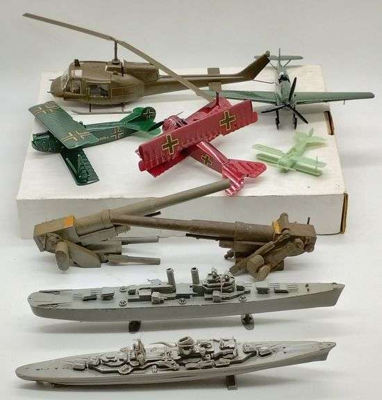 (DE) Model planes (8" wingspan), Helicopter (13" long), ships (12" long), and wooden anti aircraft guns (8" long).
