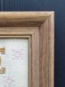 (Q) Framed Counted Crosstitch Piece Featuring Saying "Home Is Where The Heart Is"