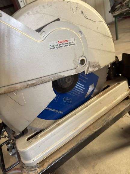 Makita chopsaw on rolling stand with diamond blade and metal stand