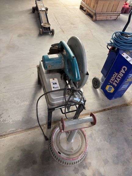 Makita chopsaw on rolling stand with diamond blade and metal stand