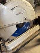 Makita chopsaw on rolling stand with diamond blade and metal stand