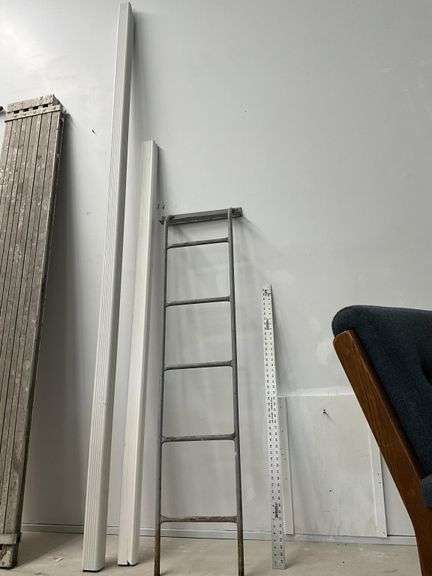 Metal ladder and plastic downspout