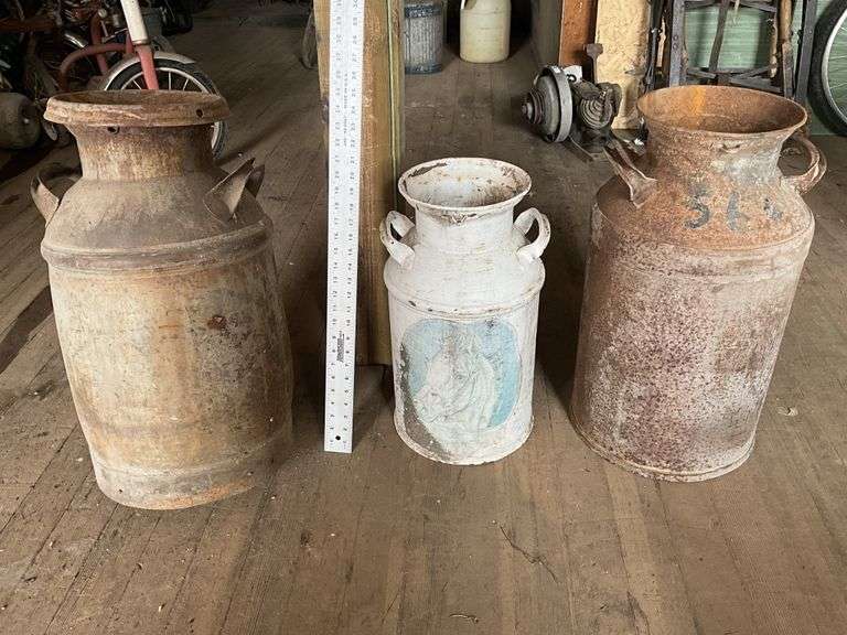 3 rusty milk cans