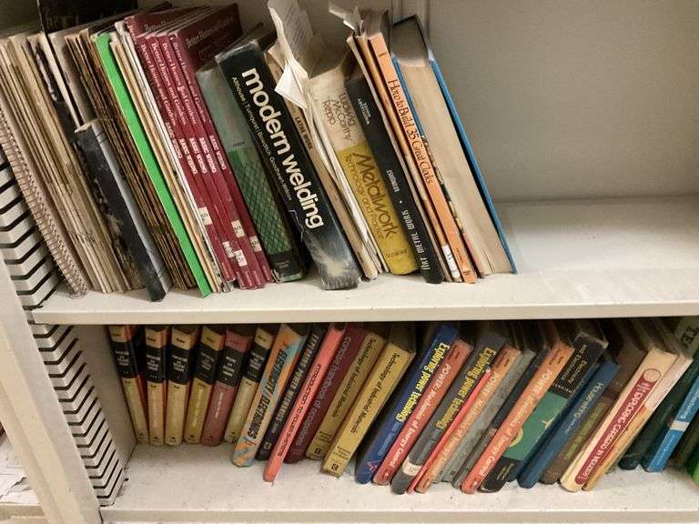 Metal shelving unit with assorted books.