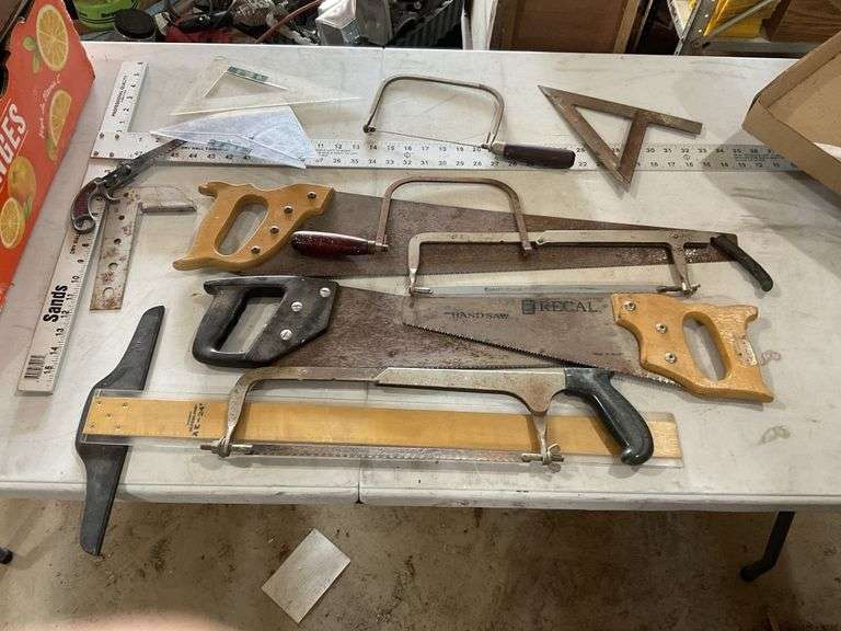 Assorted saws and squares. handsaws, coping saws,