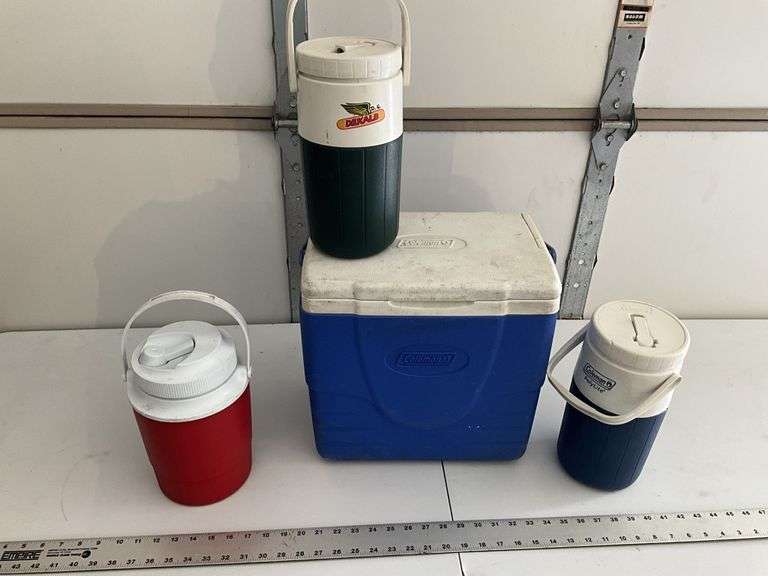 Coleman cooler and water jugs. One water jug,