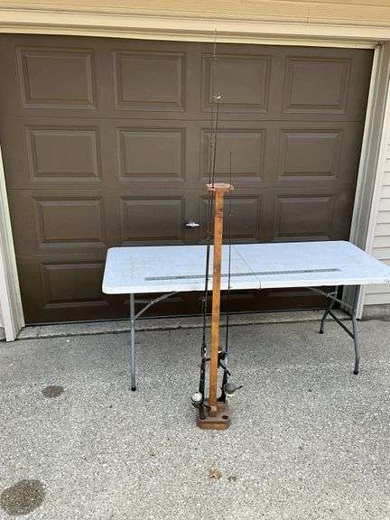Three fishing poles with fishing pole stand