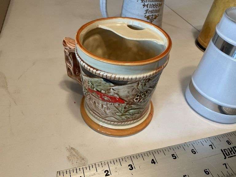 Assorted beer steins and shaving mug