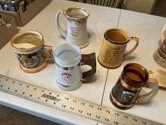 Assorted beer steins and shaving mug