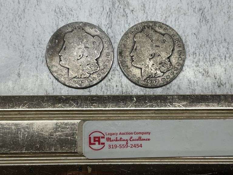 2- Morgan silver dollars 1897 O, 1902 O