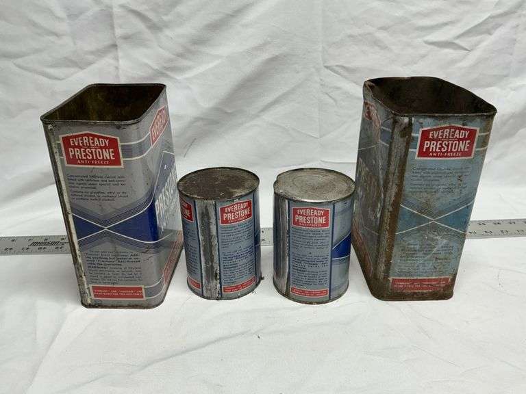 Prestone antifreeze cans (2 full, 2 empty)