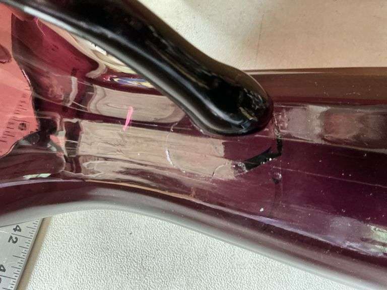 Purple glass pieces-pitcher has a crack by handle
