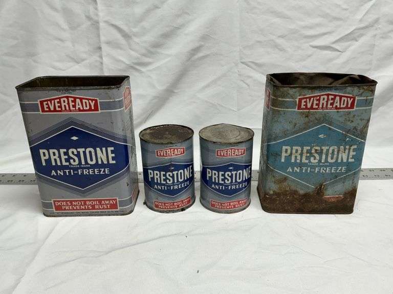 Prestone antifreeze cans (2 full, 2 empty)